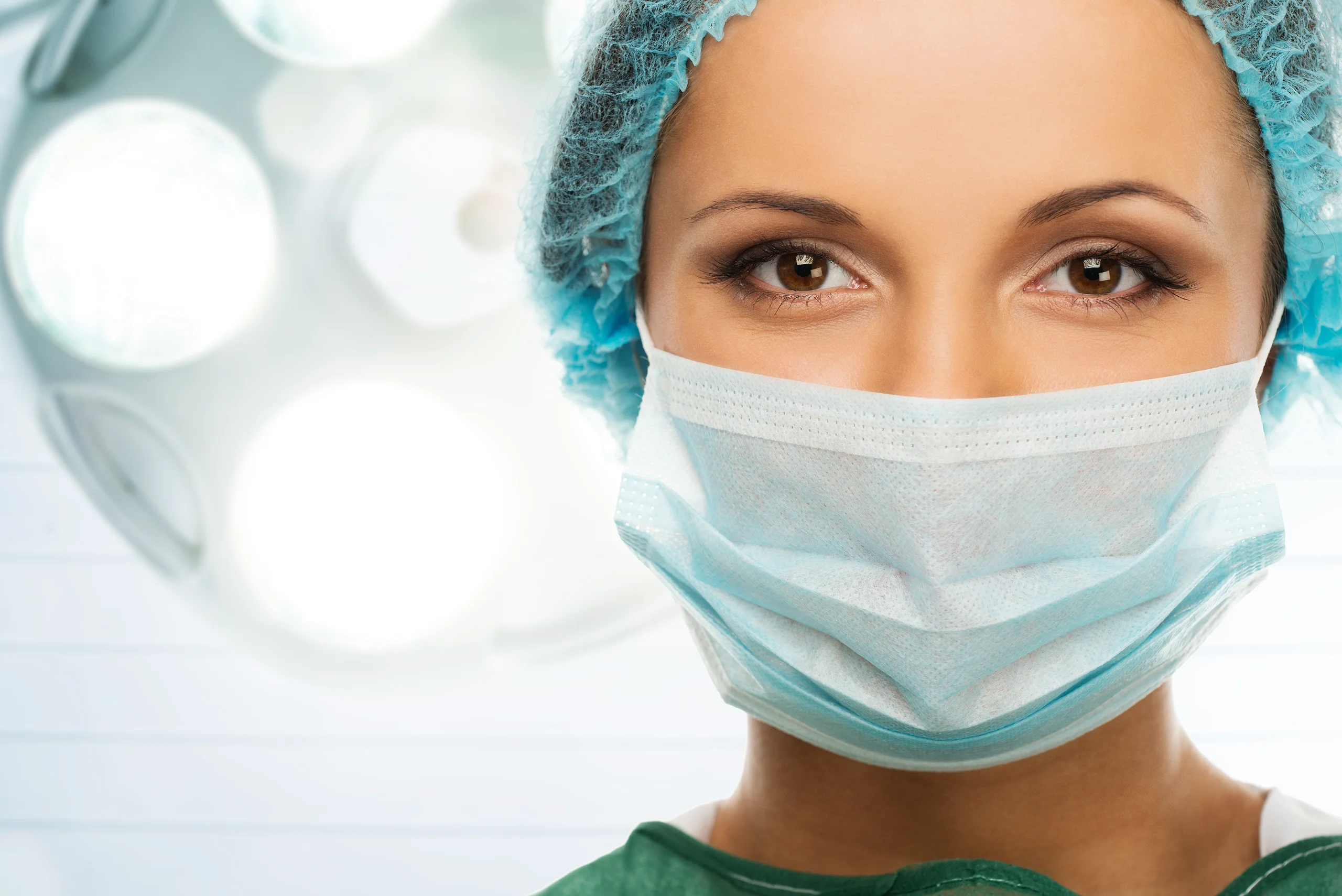 Healthcare professional wearing a surgical mask and cap